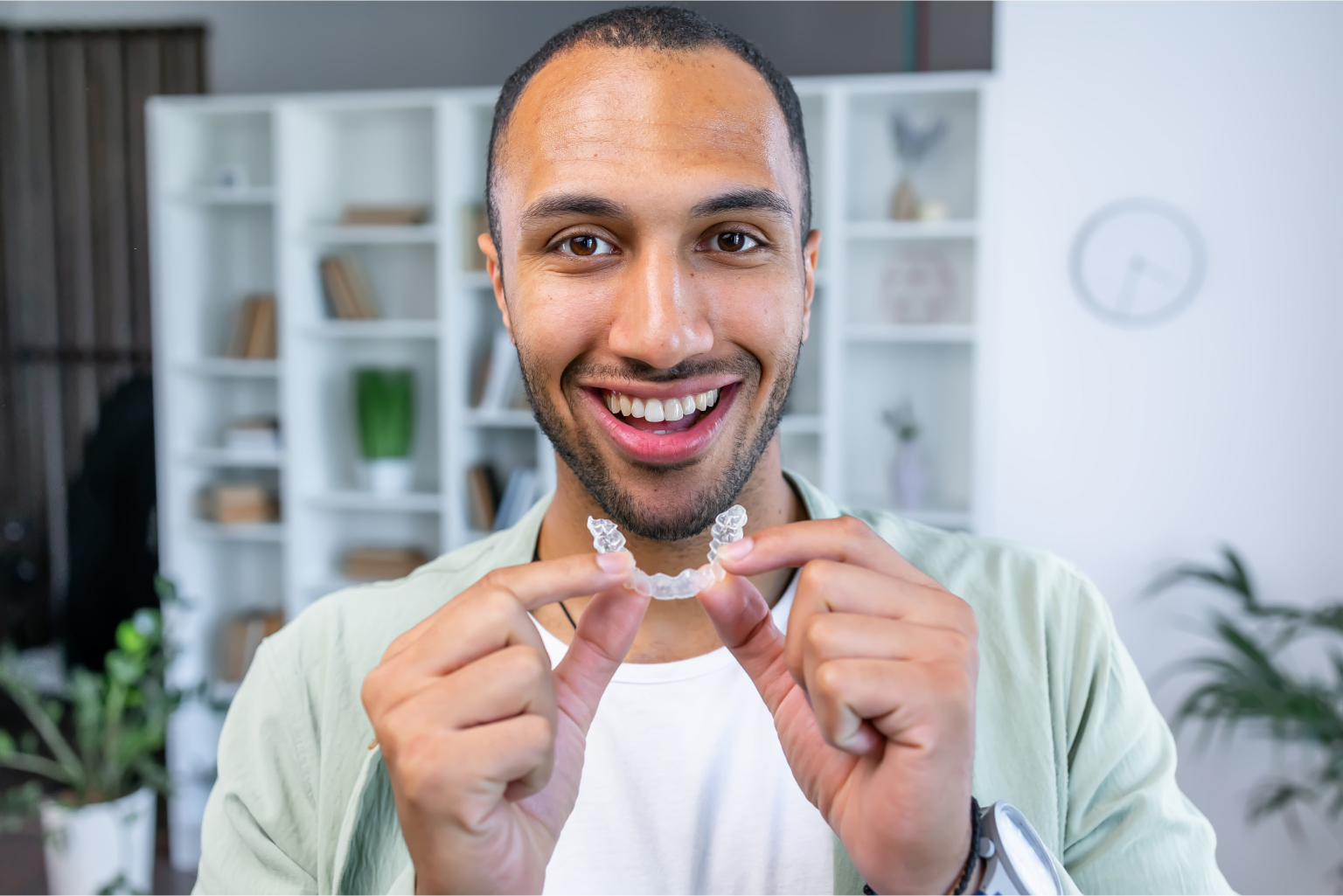 Man holding clear aligners