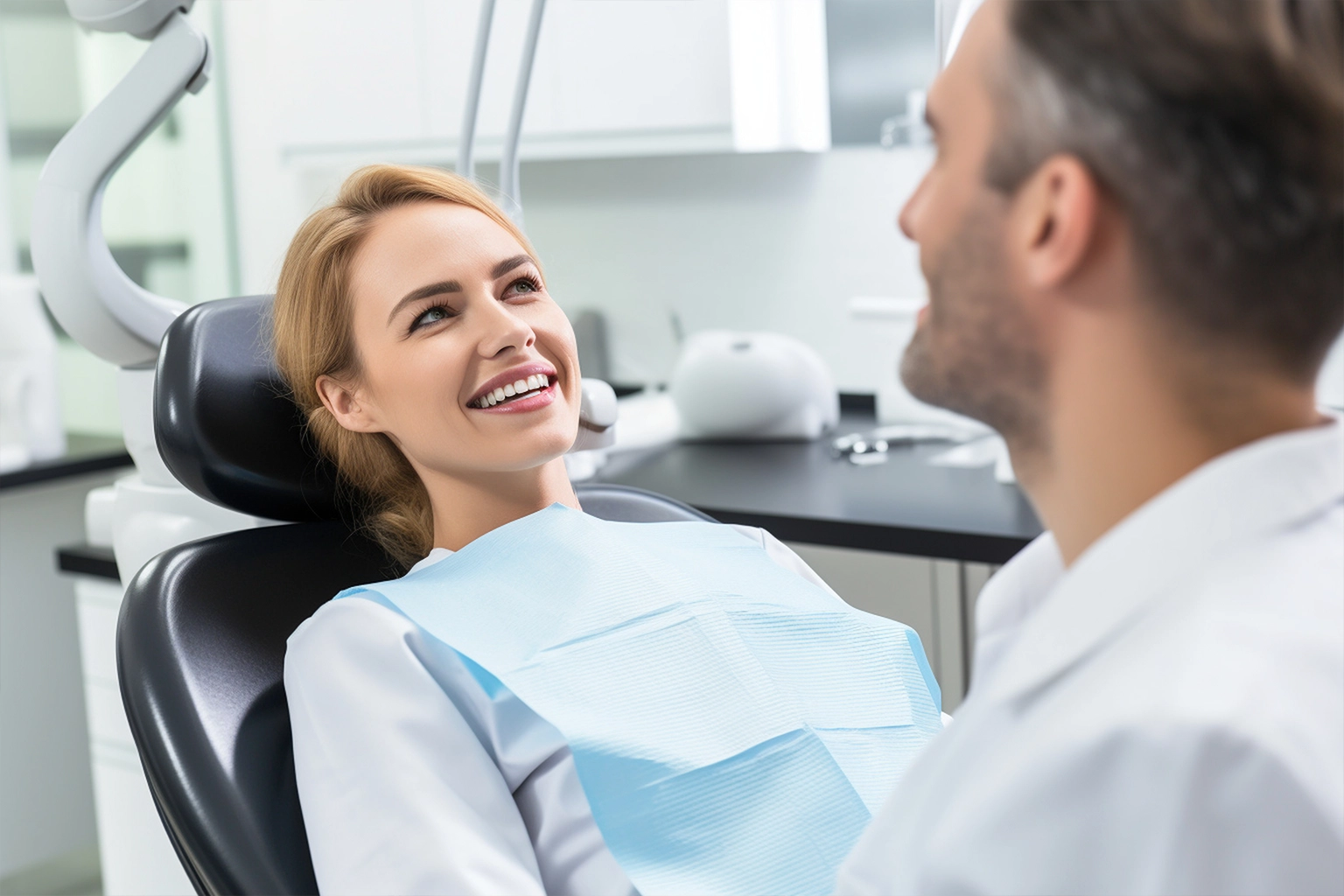 Female patient smiling after a successful dental procedure with her dentist