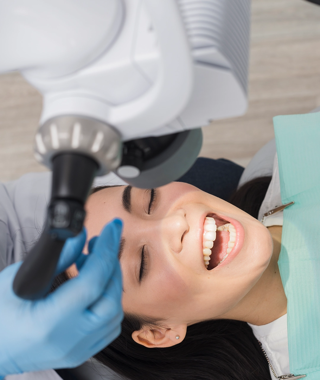 Woman receiving professional teeth whitening treatment