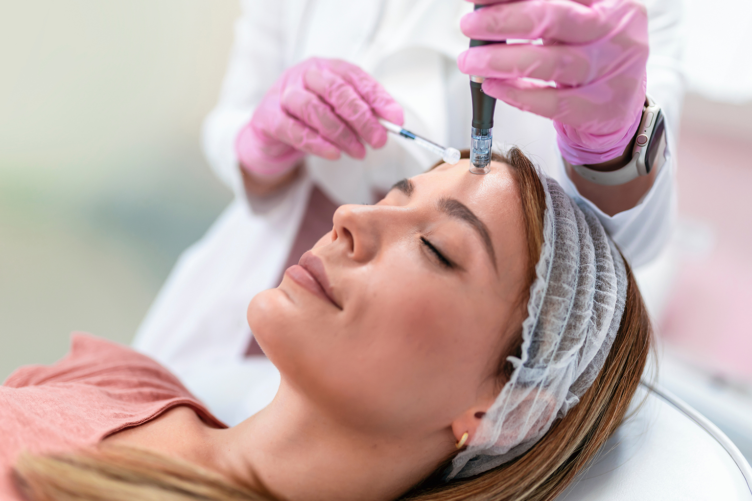 Woman receiving a facial mesotherapy treatment on her forehead to reduce wrinkles and rejuvenate skin