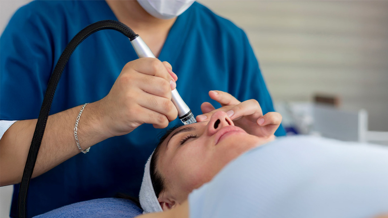 Hydrafacial treatment being performed on a woman’s face